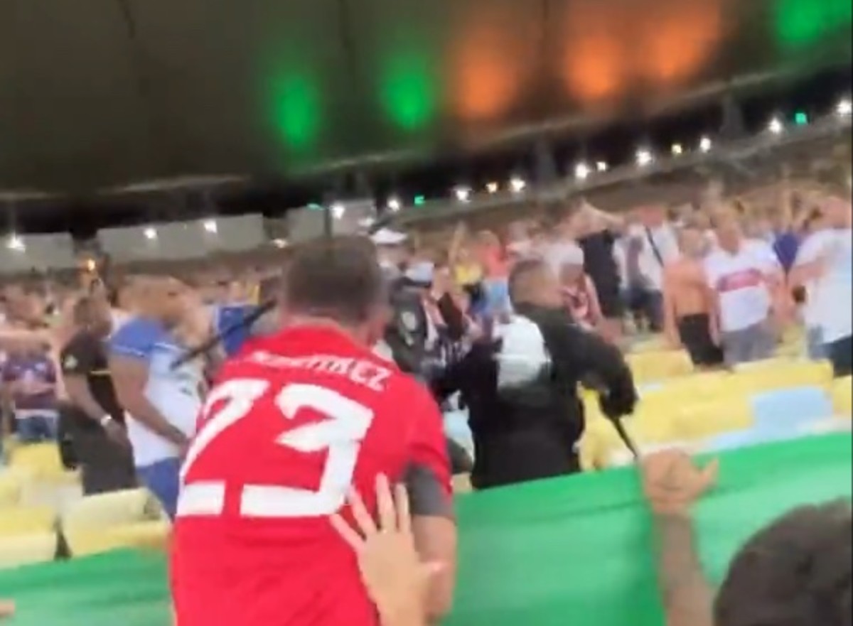 Goalkeeper Emiliano Martinez pictured trying to slap a baton from an officer's hand after witnessing clashes between police and Argentina fans at Brazil's Estadio do Maracana in November 2023